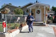 Letter carrier Ray Mayland delivers mail to the home of deceased murder suspect Bruce Pardo, Friday, Dec. 26, 2008, in Montrose, Calif. A ninth body was found Friday morning at the charred site of a Christmas Eve massacre where Pardo, who showed up dressed as Santa Claus at his ex-wife's parents' party, killed at least nine people before setting the home on fire and later killing himself. 